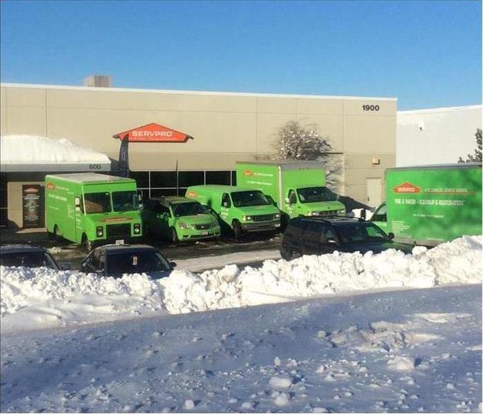 SERVPRO office, snow is surrounding vehicles parked in front of the building